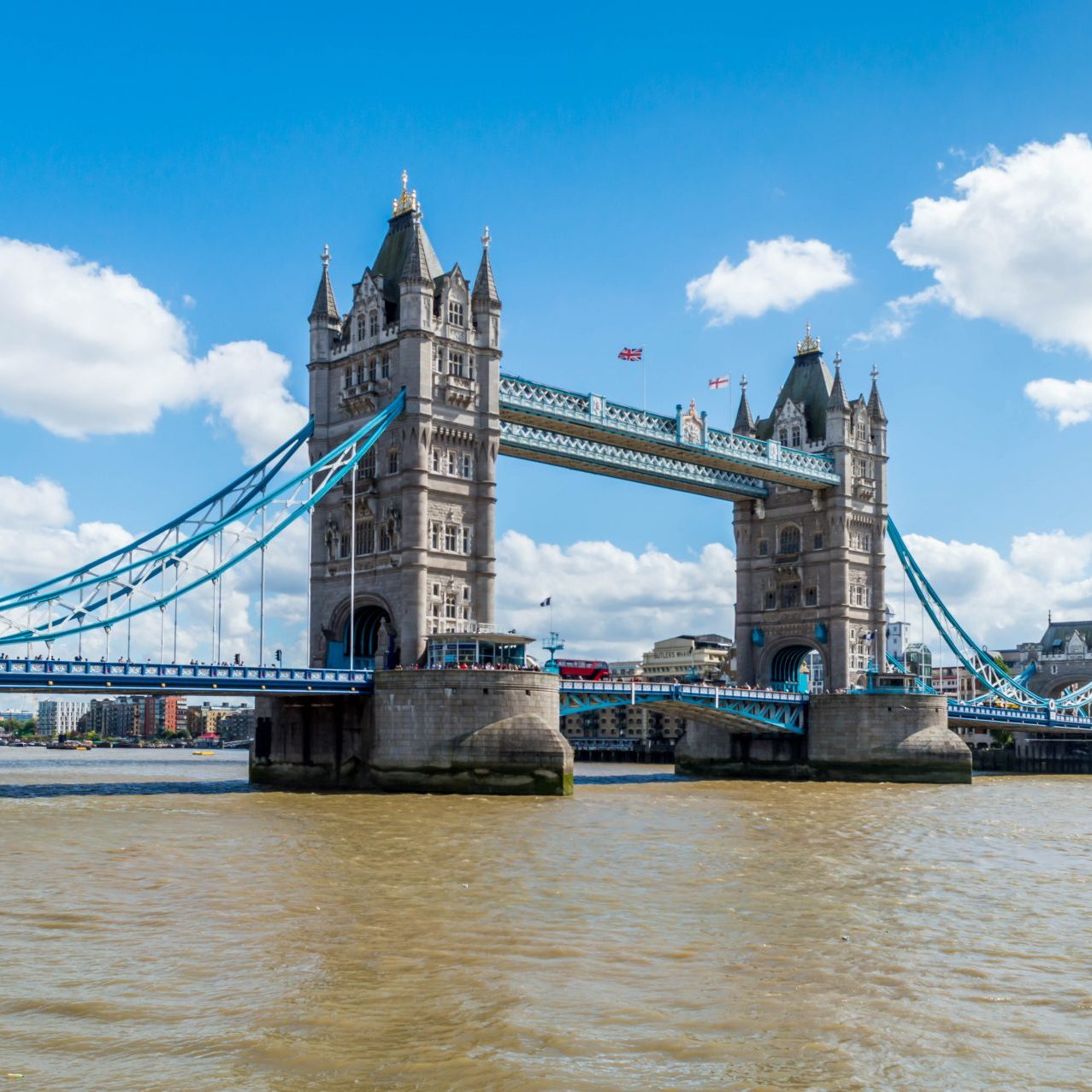 London, UK - 7 August, 2016: Tourists are walking through the bridge, while cars and buses are passing.